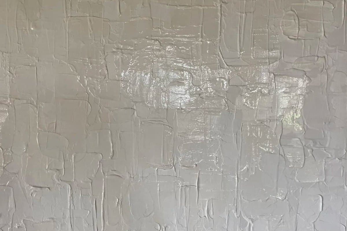Detalle del lienzo blanco Blanc Immaculé trabajado a espátula: el relieve de la materia y un reflejo brillante en el centro de la superficie